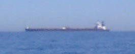 If this grainy photo doesn’t look impressive look again - the tiny bridge on the stern of the vessel is 8 stories high © SW